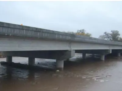 beaver dam bridge with water flooding below